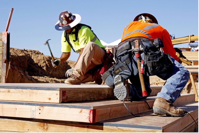 Two men engaged in construction activities