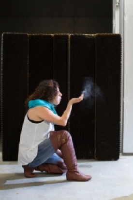 girl blowing dust